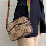 Tan GG monogram canvas messenger crossbody bag with brown trim and striped web strap