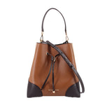 Brown bucket crossbody bag with black trim and drawstring closure, medium