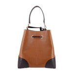 Brown medium bucket crossbody with black colorblock panels and metal drawstring ring