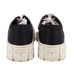Prada black platform sneakers with rear branding on textured light midsoles