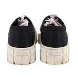 Prada black platform sneakers with rear branding on textured light midsoles