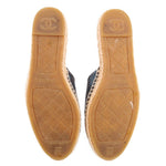 Outsoles of blue espadrille flats with tan rubber and CHANEL logo