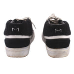 Black high-top sneakers with gray laces, white stripe, and M1 heel tabs