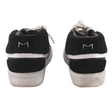 Black high-top sneakers with gray laces, white stripe, and M1 heel tabs