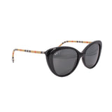 Cat-eye sunglasses with dark lenses; check-pattern arms in black, beige, red accents