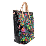 Rita sling crossbody negro con flores multicolor y asa de cuero