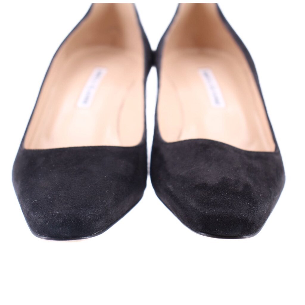Black suede pumps close-up with light inner lining at the opening