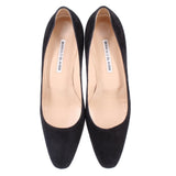 Pair of black suede pumps with interior footbeds and curved topline