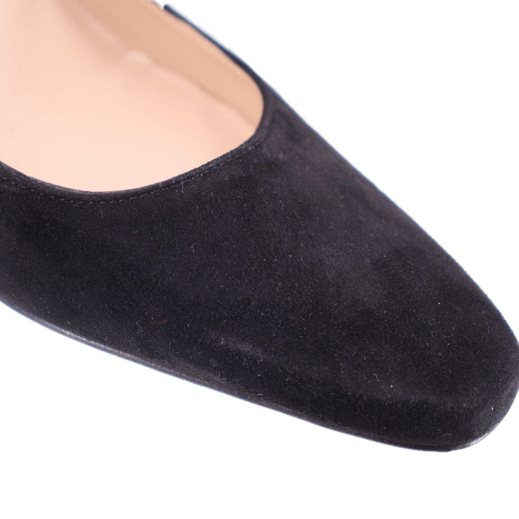 Black suede pointed toe pump close-up with smooth vamp seam