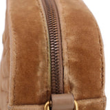 Brown velvet crossbody bag close-up of side zipper and leather tab