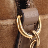 Brown velvet crossbody bag close-up of ring clasp and leather strap