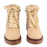 Pair of tan lace-up combat boots showing front and laces.