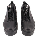 Pair of black platform sneakers with lace-up eyelets and side panels