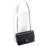 Black quilted jumbo double flap shoulder bag with CC logo on flap