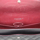 Red CHANEL-lined interior with logo and snap pocket inside black jumbo double flap bag