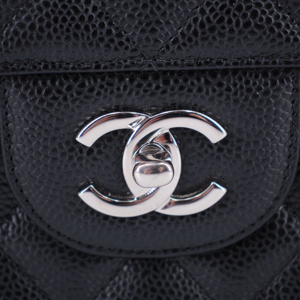 CHANEL CC logo on black textured leather front of jumbo double flap bag