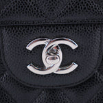 CHANEL CC logo on black textured leather front of jumbo double flap bag