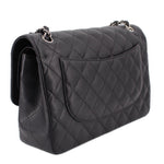 Black quilted jumbo double flap shoulder bag, side view with double chain strap and flap pocket