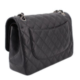 Black quilted jumbo double flap shoulder bag, side view with double chain strap and flap pocket