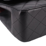 Black leather texture close-up with diamond quilting seam lines on jumbo double flap