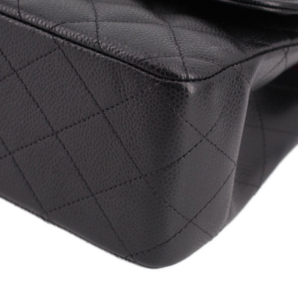 Black quilted leather corner with stitched diamond pattern on jumbo double flap bag
