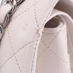 Chalk leather double flap shoulder bag close-up: textured quilted panel and stitched edge