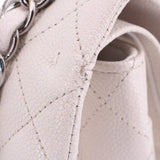 Chalk leather double flap shoulder bag close-up: textured quilted panel and stitched edge