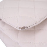 Close-up of off-white quilted CHANEL bag corner showing worn stitching