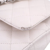 Close-up of off-white quilted CHANEL bag edge with chain hardware