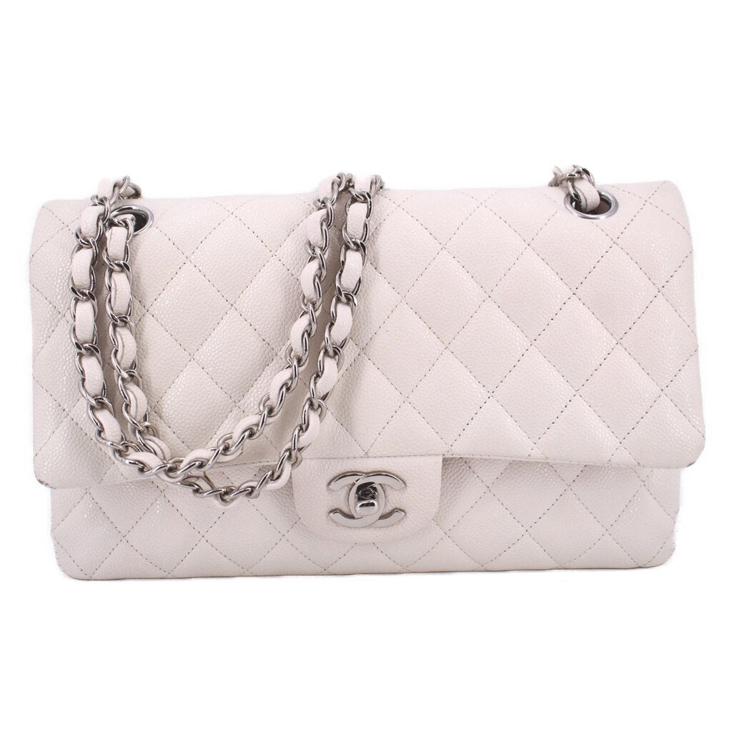 Light beige quilted double-flap shoulder bag with silver chain and turn-lock clasp.
