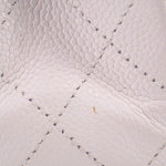 Chalk quilted leather panel detail with diamond stitching on handbag flap