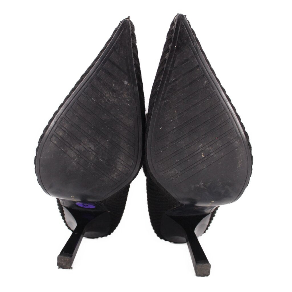 Black heeled bootie pair, pointed toe, visible outsole and heel