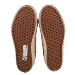 High-top sneaker outsoles with brown waffle traction tread and off-white edges