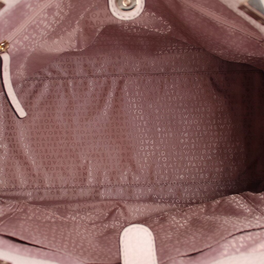 Cream fabric-lined interior of Thatcher tote with repeating logo pattern