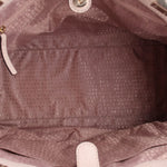 Cream fabric-lined interior of Thatcher tote with repeating logo pattern