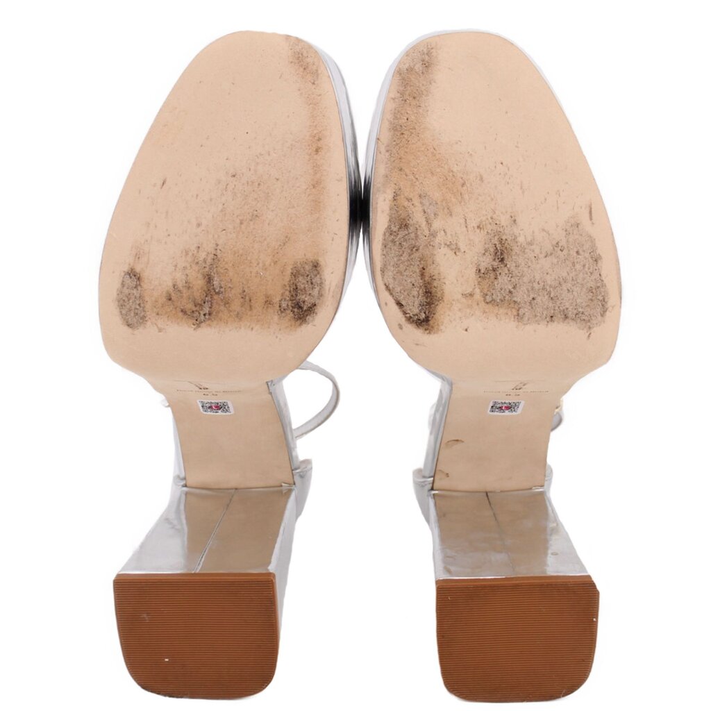 Silver metallic platform heels showing insoles and outsole tread
