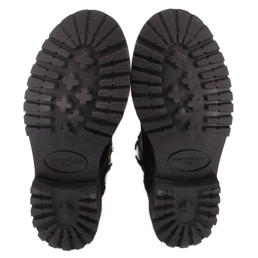 Black boot soles with deep tread and oval logo embossing