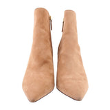 Camel suede ankle booties, side zippers visible, pointed toe and slim heel.