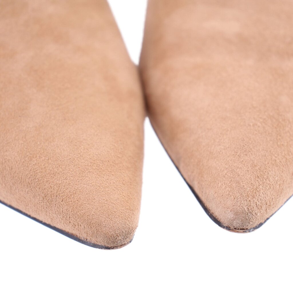 Close-up of camel suede pointed toe and slim boot heel