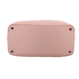 Pink satchel base with four metal feet and smooth pebbled finish