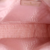 Pink satin-lined interior with monogram-style pattern and stitched logo panel