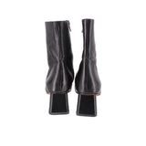 Black leather ankle booties showing back seam and chunky block heel