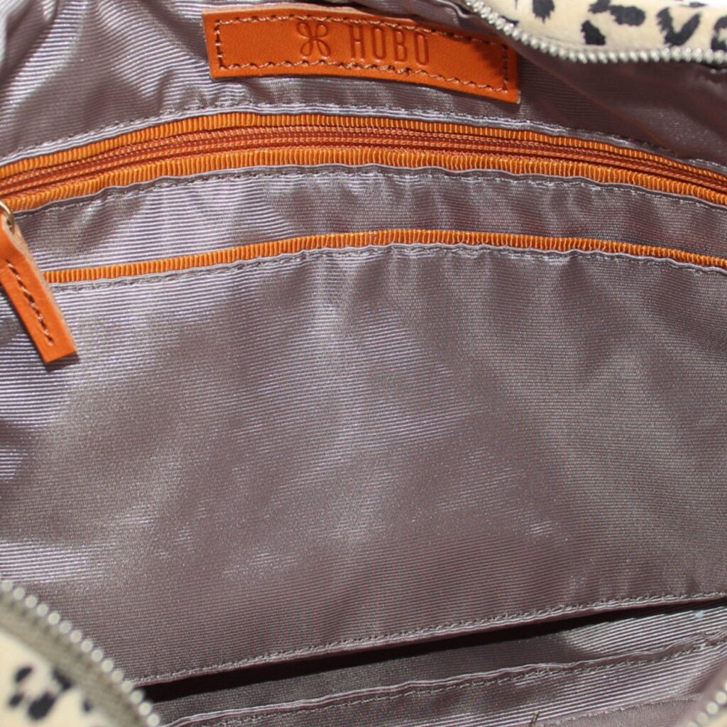 HOBO mini crossbody interior view with orange zipper and fabric lining