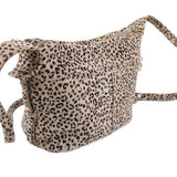 Leopard print mini leather crossbody bag with top zipper, front seams, and crossbody strap
