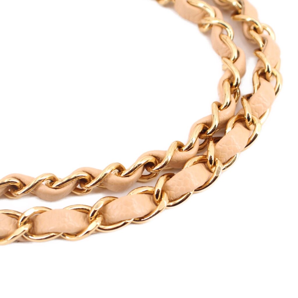 Tan leather shoulder strap with gold chain links and clasp hardware