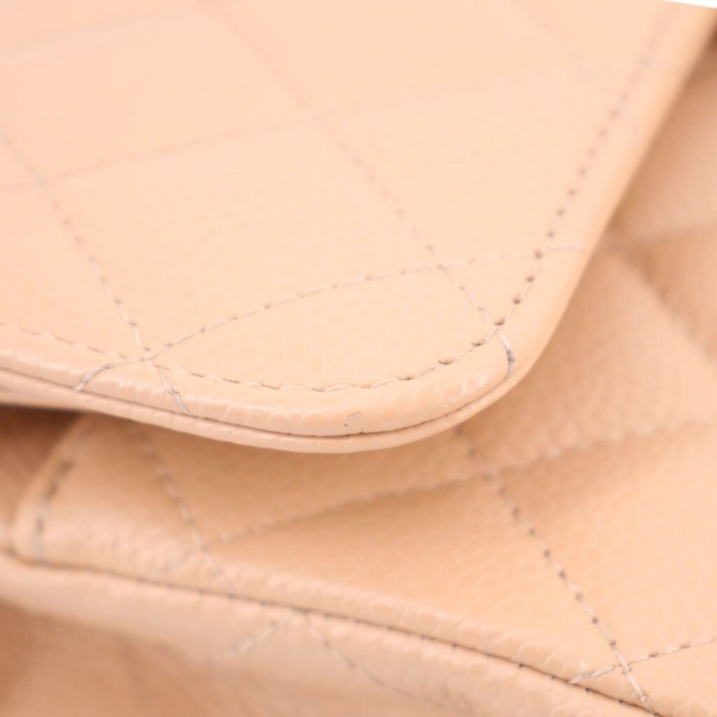 Tan inner fold close-up with quilted panels and contrast stitching