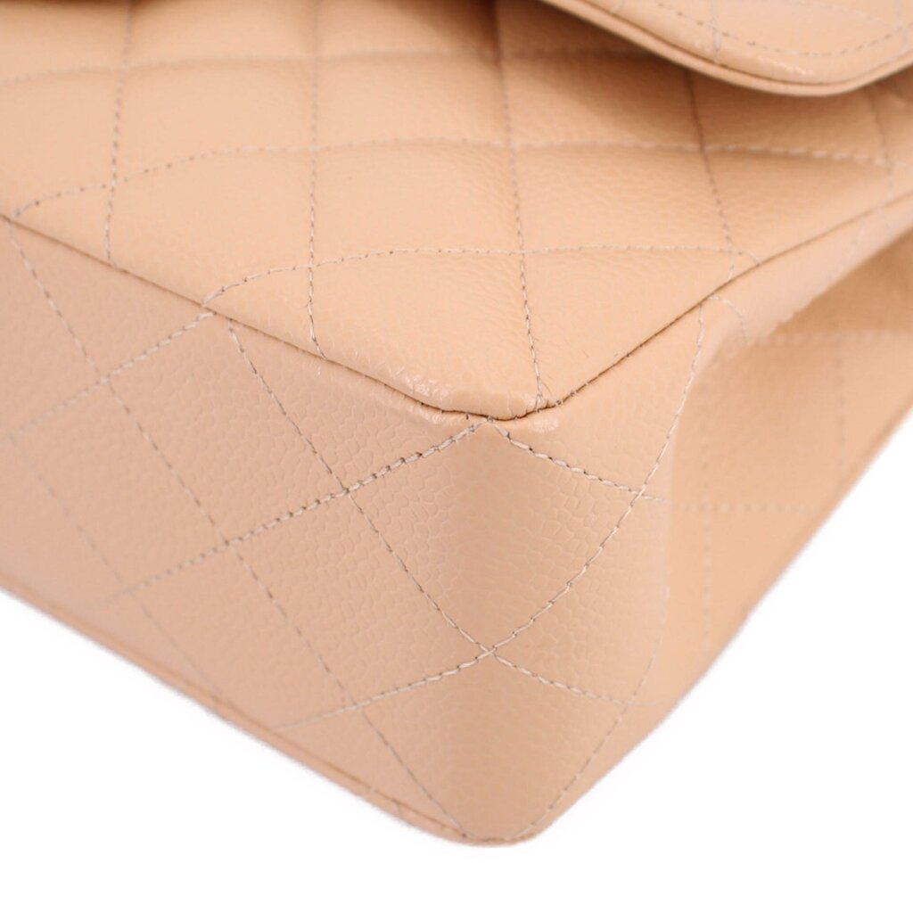 Tan quilted leather bag corner detail with curved edge and visible stitching