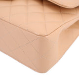 Tan quilted leather bag corner detail with curved edge and visible stitching