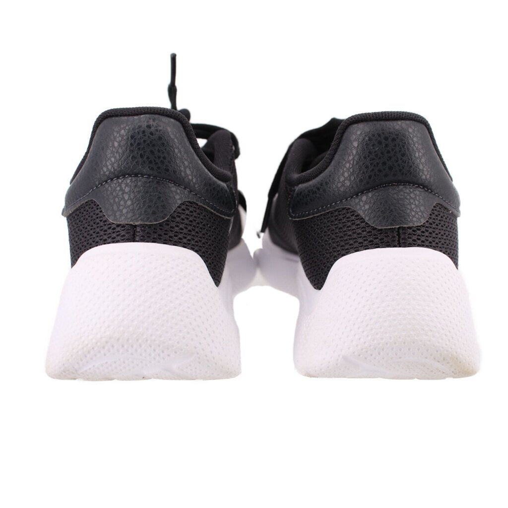 Black sneakers with textured heel panels and white foam sole