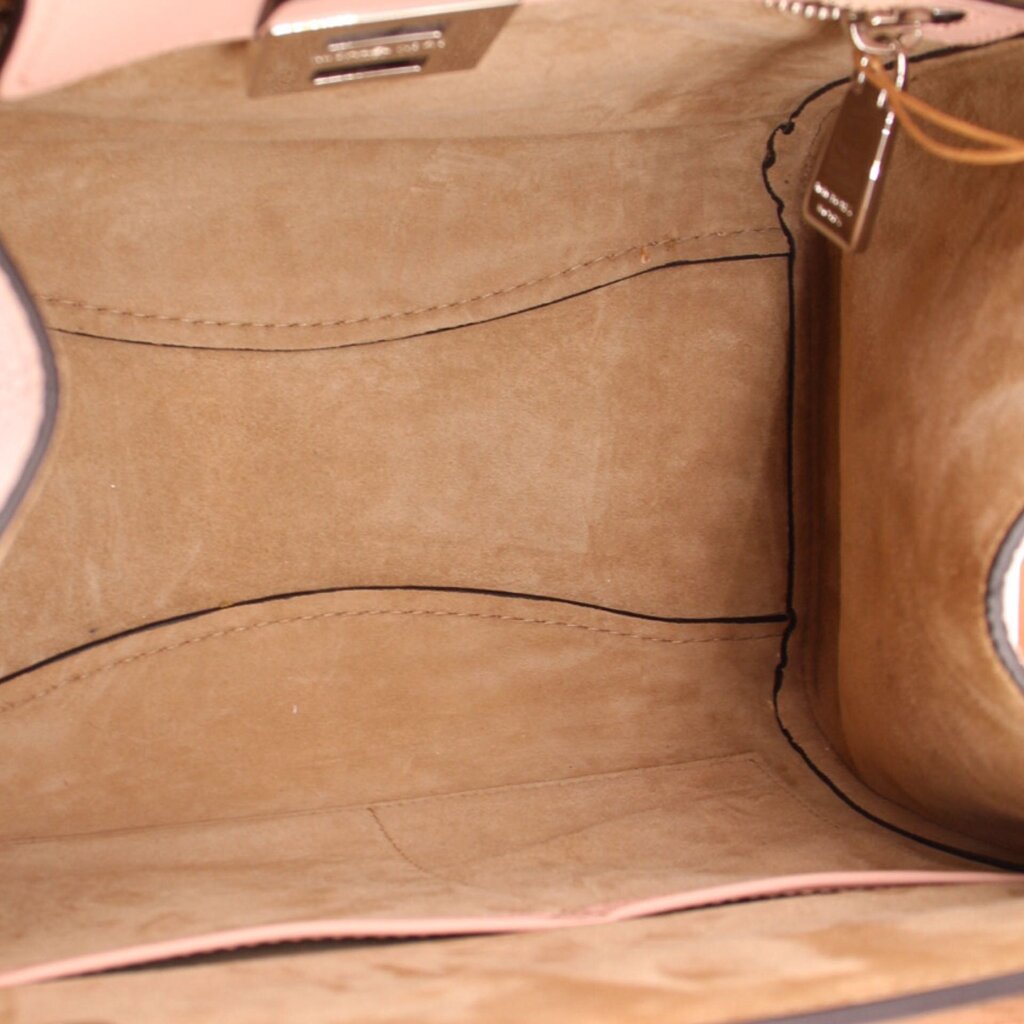 Pebbled leather bag interior with tan lining and stitched side wall